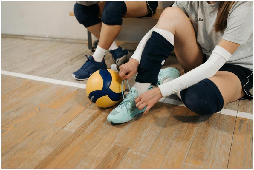 Volleyball players tying shoes and preparing on a