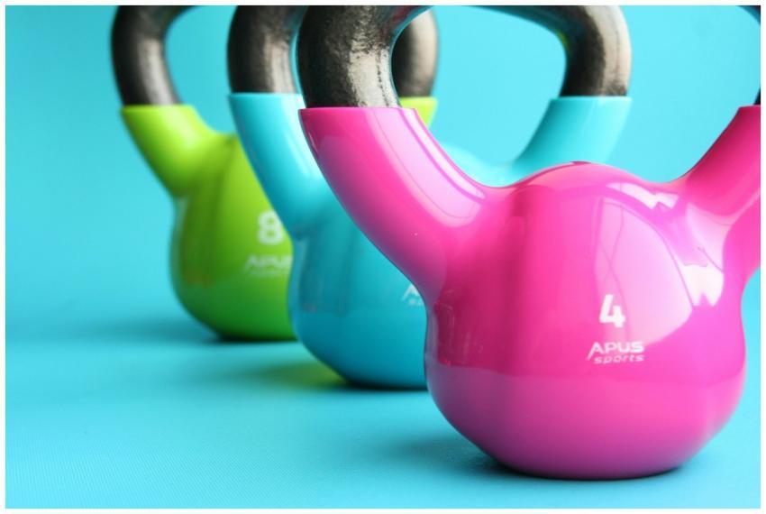 Vibrant colored kettlebells on blue background hig