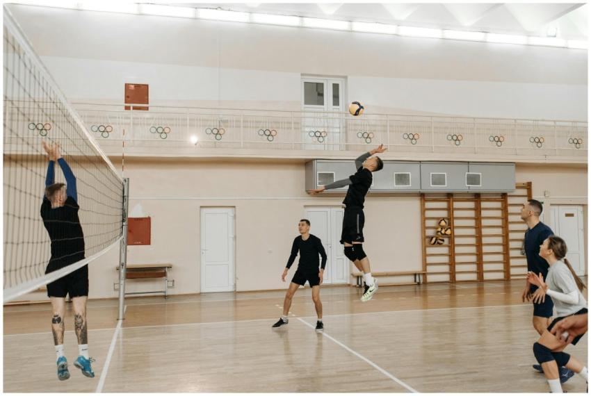 Competitive indoor volleyball match with athletes