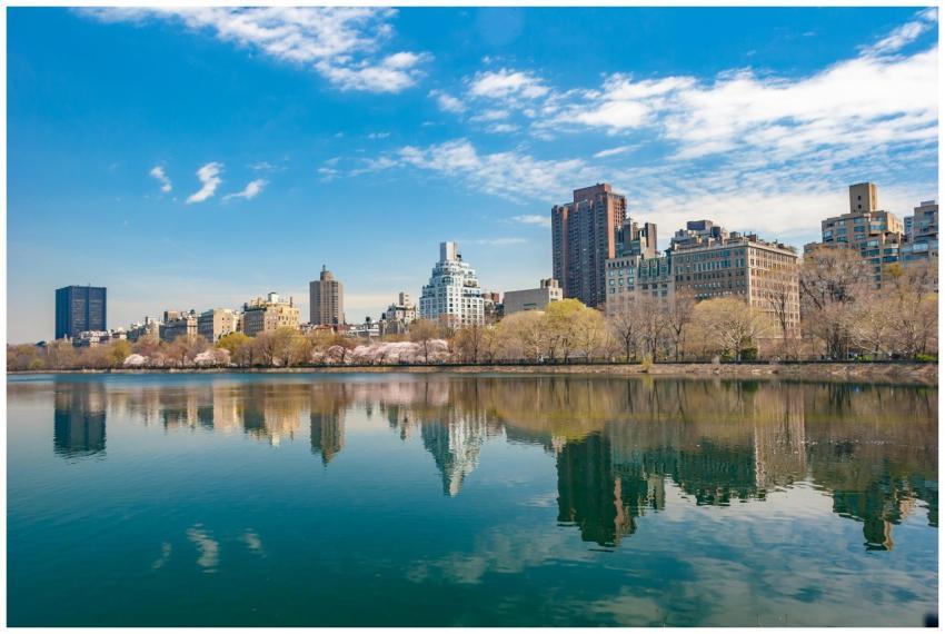 New York City skyline reflecting in Central Park's