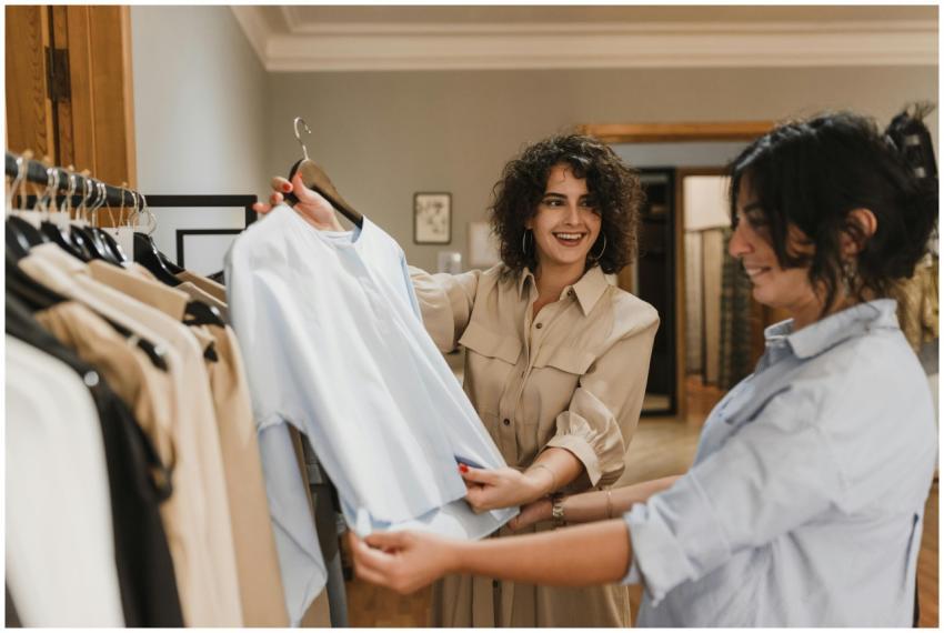 Two women shopping at a clothing store, enjoying a