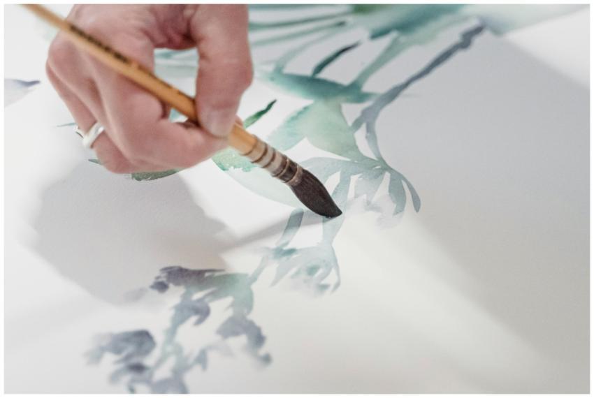 Close-up of a hand using a brush to create waterco