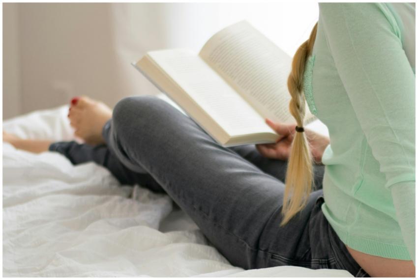 Woman relaxes while reading a book in a cozy indoo