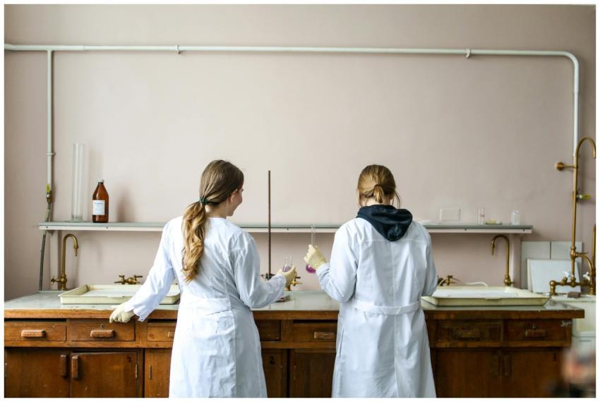 Two female scientists working on an experiment in