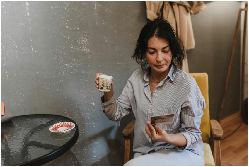A woman in a casual setting enjoying tea and looki