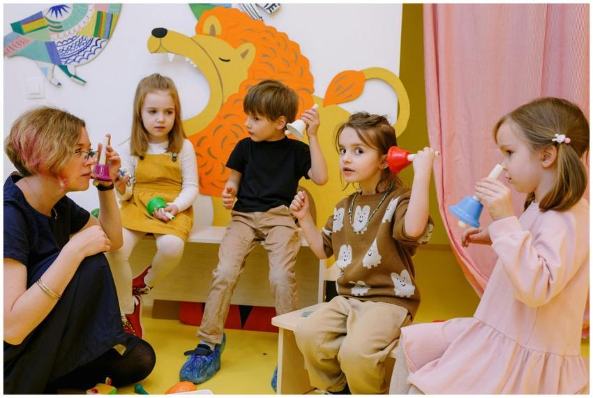 Young children playing musical bells in a colorful