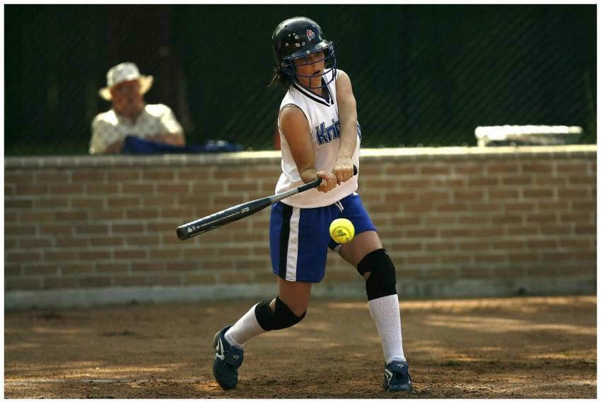 A female athlete concentrating while batting durin