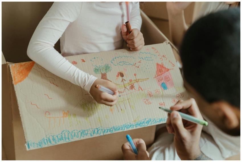 Kids enjoying creative time drawing on a cardboard