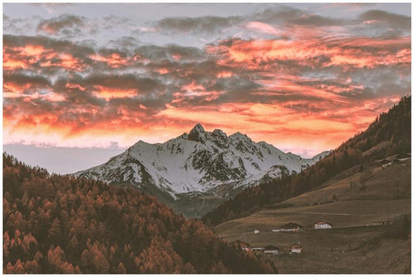 Stunning sunset over snow-capped mountains with vi