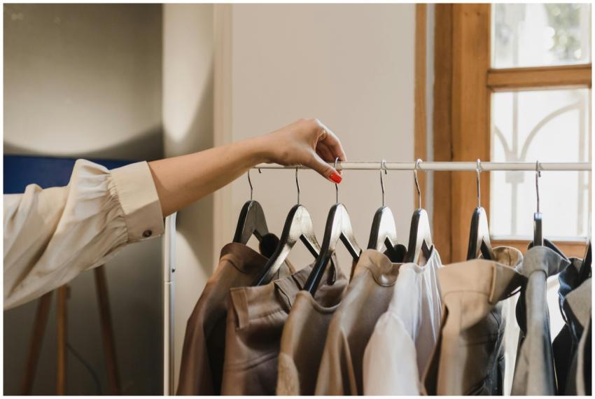 A woman's hand with red nails selecting leather ja