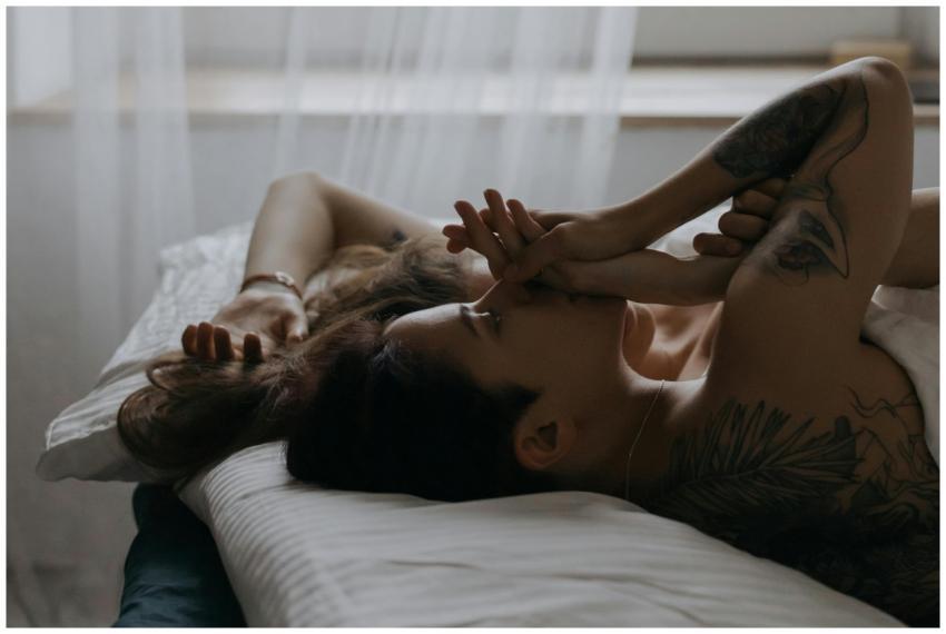 A serene moment between a couple lying in bed, sho