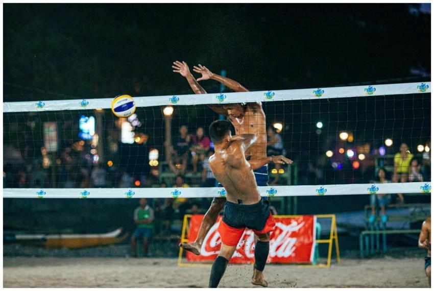 Energetic beach volleyball match under night light