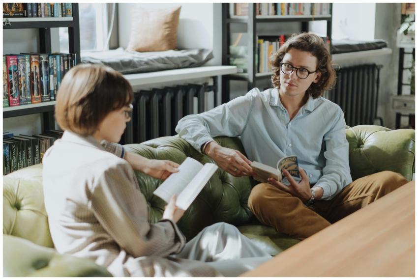 Two young adults enjoying a cozy moment reading an