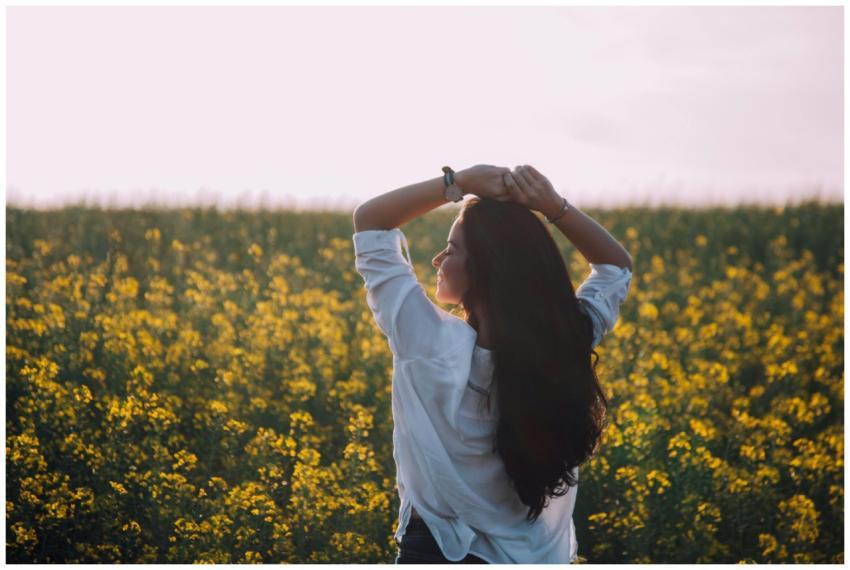 Woman in white shirt enjoying a sunny day in a blo