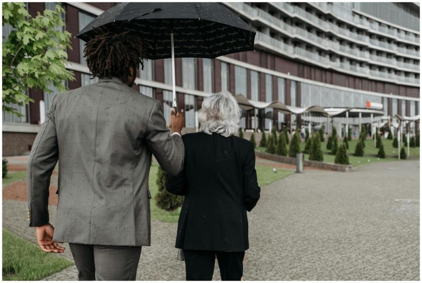 Two business professionals walk together under an