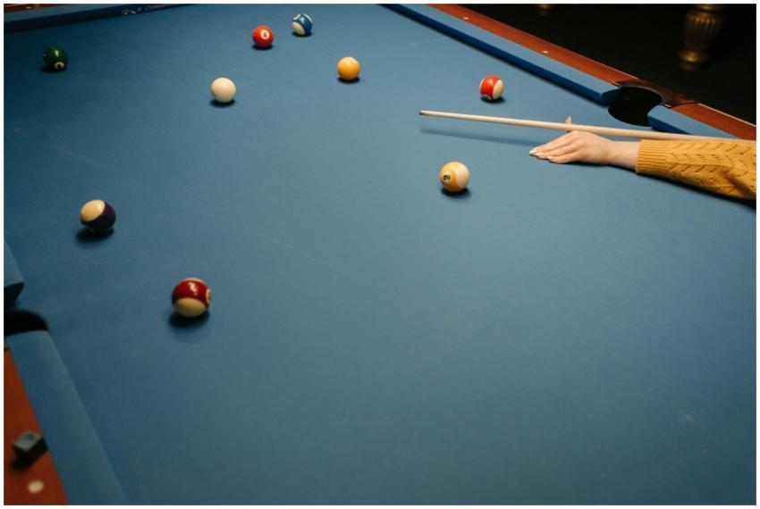 Close-up view of a pool game in action on a blue b