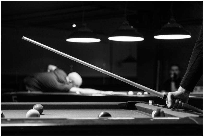 Black and white image of people playing billiards