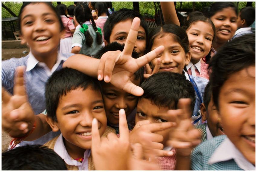A joyful group of children smiling and making play