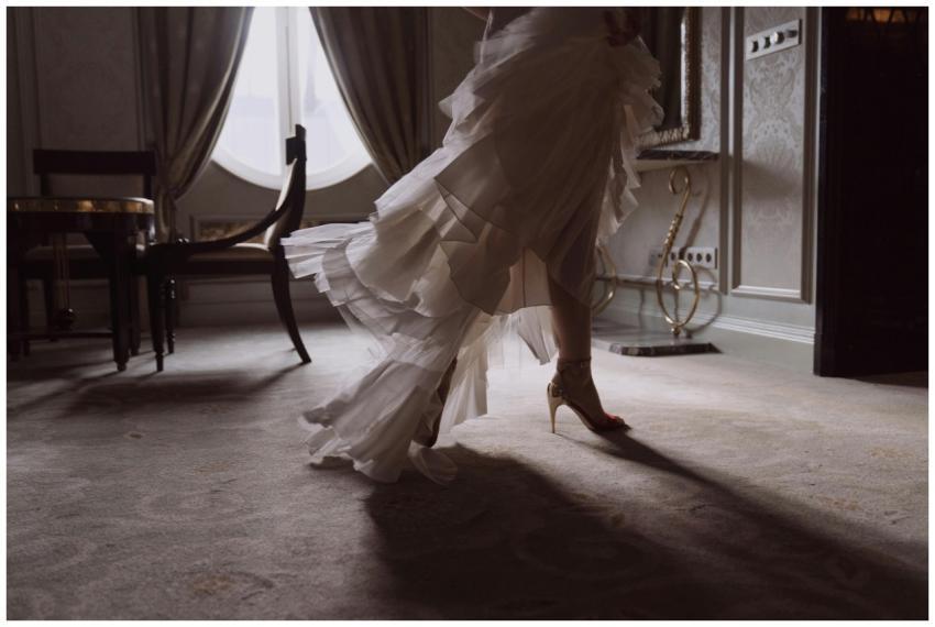 A lavish white wedding dress with high heels in an