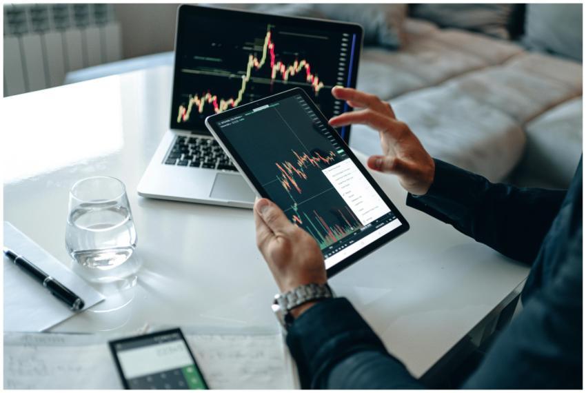 Close-up of a person using a tablet for online tra