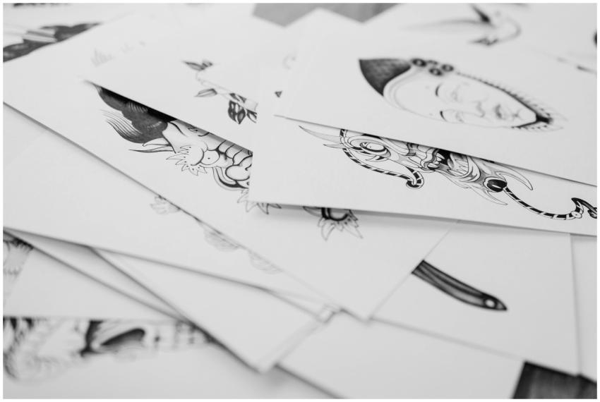A collection of detailed tattoo design sketches in