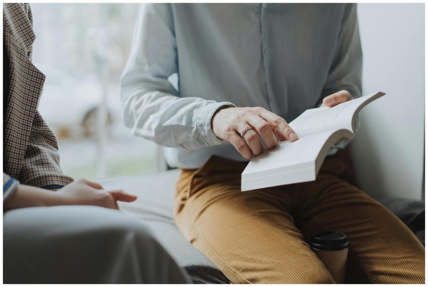 A cozy indoor reading session with two adults disc