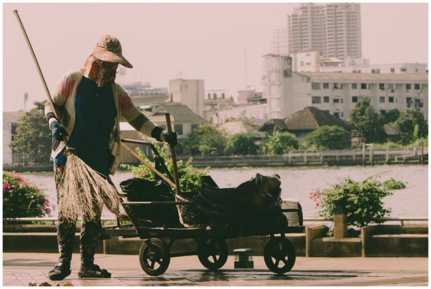 A hardworking woman cleaning the riverside in Bang