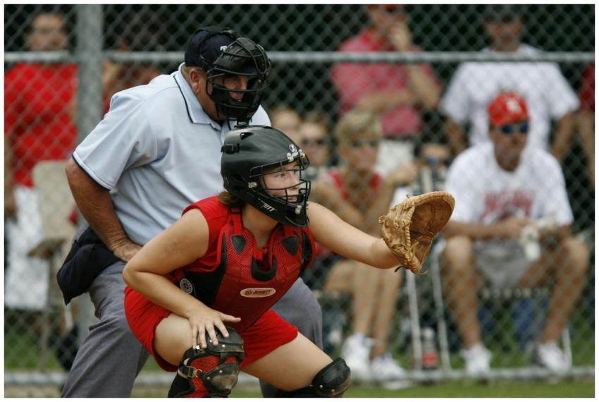Female catcher in action during a baseball game, s
