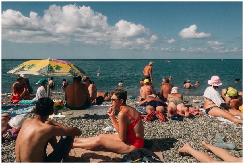 A vibrant scene of people relaxing and sunbathing