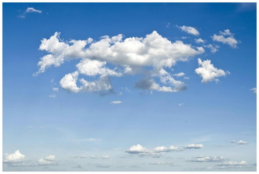 A peaceful blue sky filled with fluffy cumulus clo