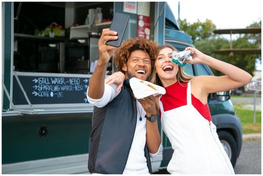 Joyful multiracial friends embracing and taking se