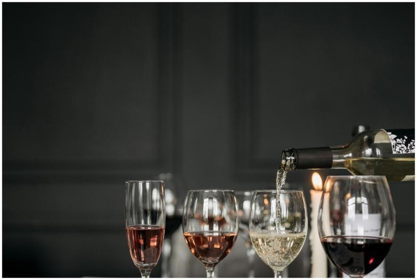Three wine glasses with red, white, and rosé wine