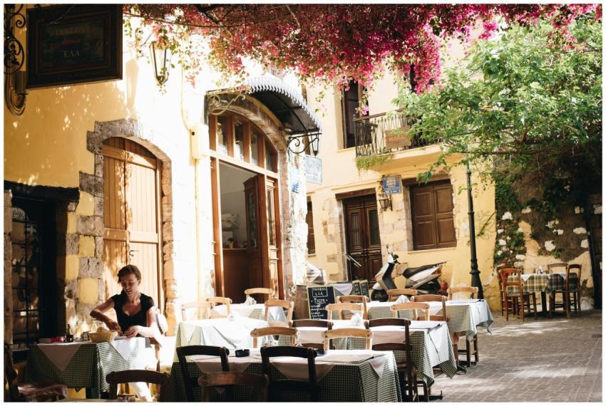 A quiet outdoor cafe in Chania, Greece, under sunl