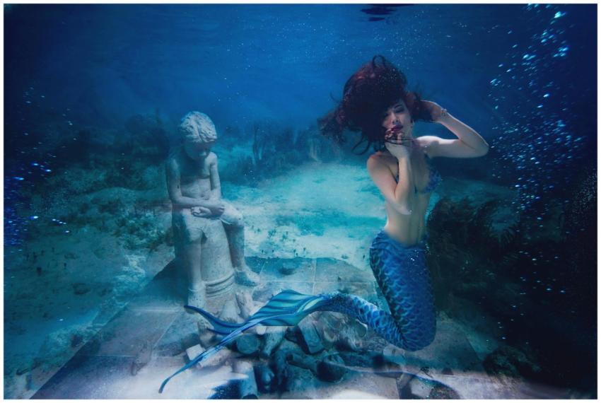 A captivating shot of a mermaid underwater near a