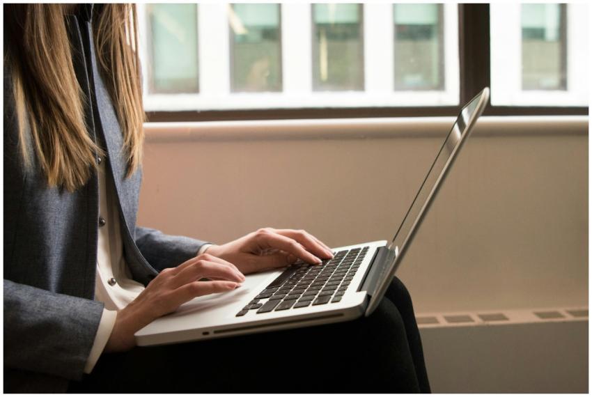 A woman working remotely on a laptop in a contempo