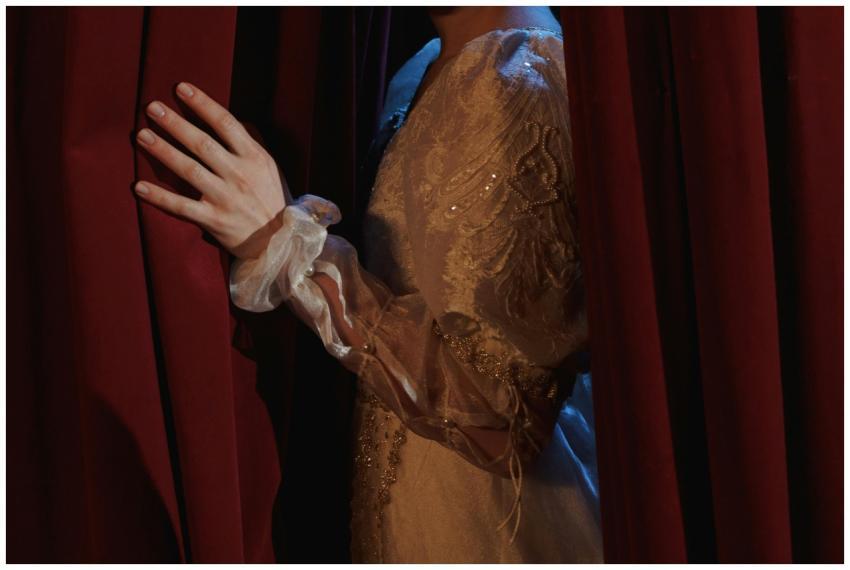 An actress in a vintage costume gracefully pulls b