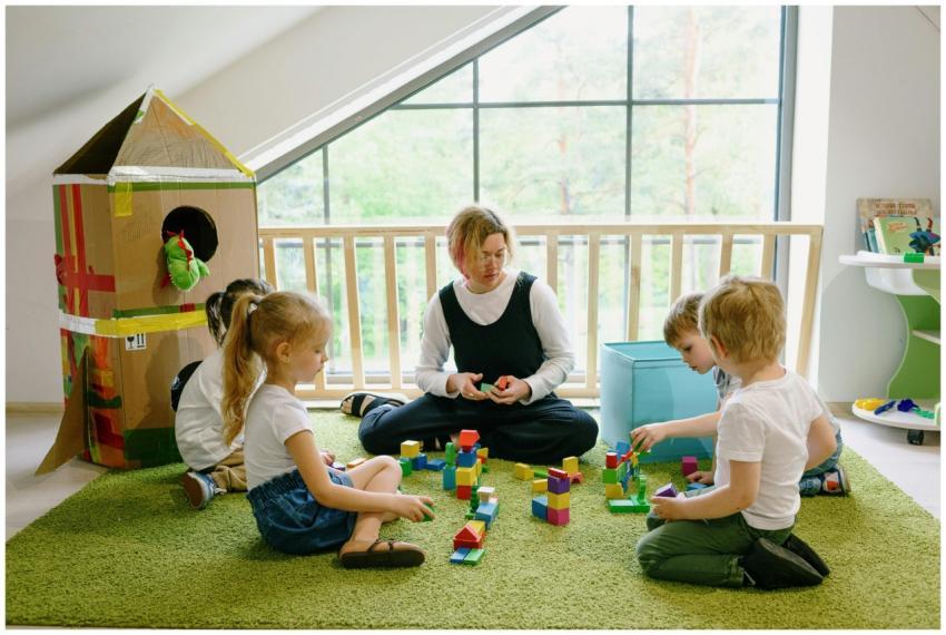 Children enjoying playtime with blocks and cardboa