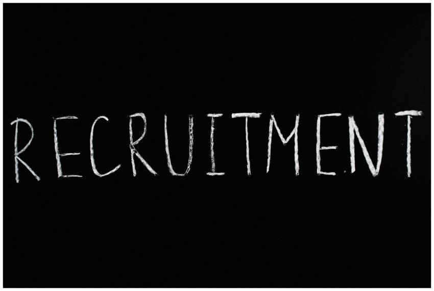 Chalk-written 'RECRUITMENT' on a black chalkboard,