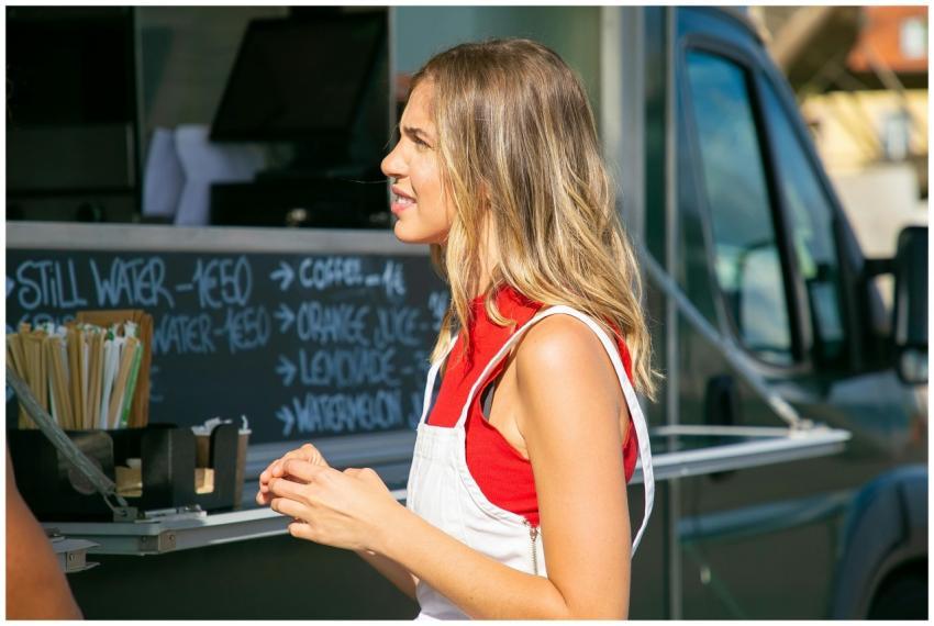 Young woman deciding on her order at an outdoor fo