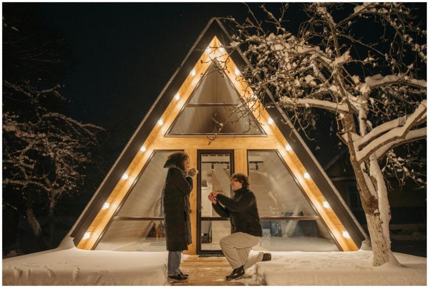 Romantic winter night proposal at cozy A-frame cab