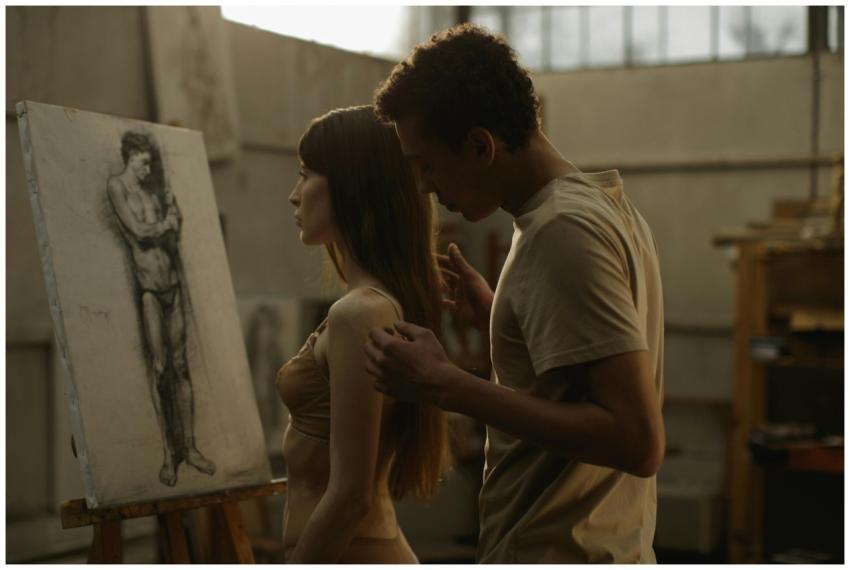 A couple in an art studio, displaying intimacy and