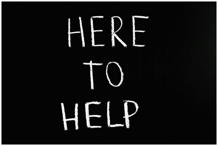 White text 'Here to Help' on a minimalist black ch