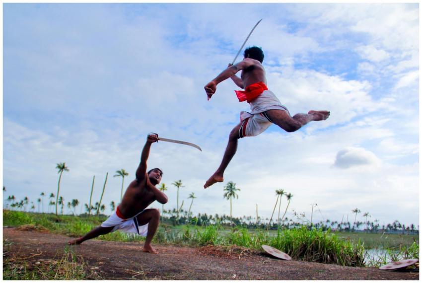Two men perform Kalaripayattu, an Indian martial a