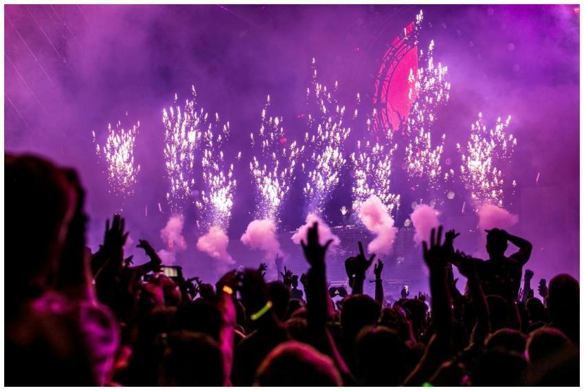 Vibrant EDM concert scene with fireworks, smoke, a