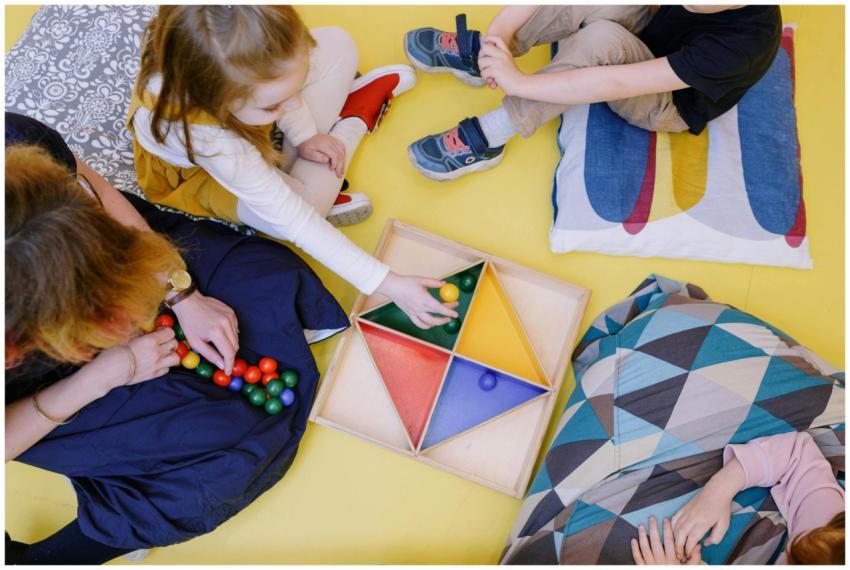 Kids engaged in playful learning with colorful toy