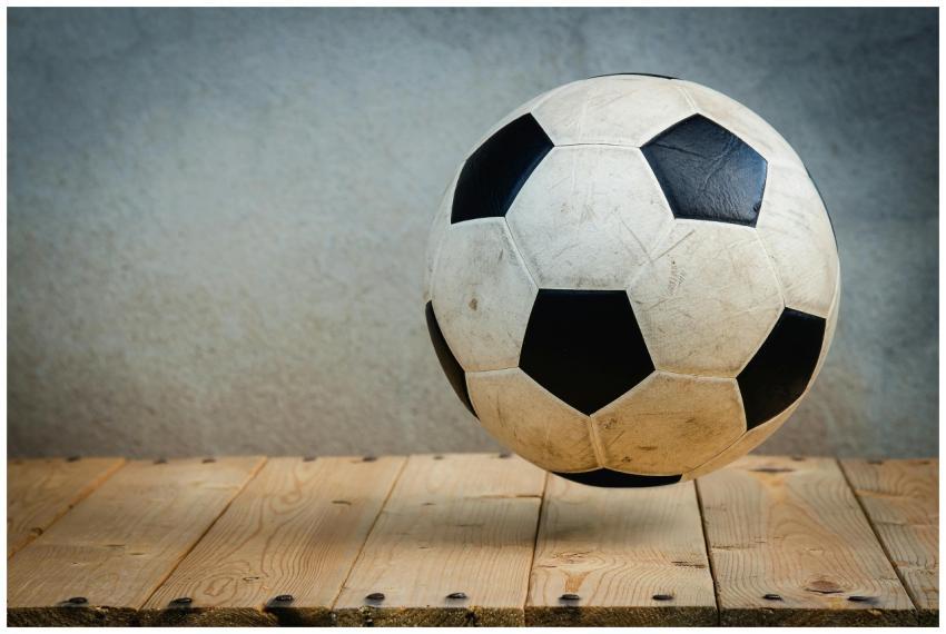 Vintage soccer ball resting on wooden planks again