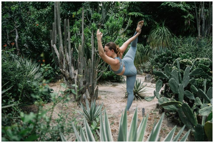 A woman performing a yoga pose in a verdant desert