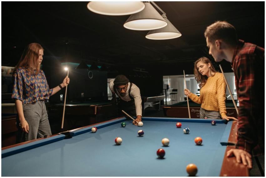 A group of friends enjoying a game of billiards at