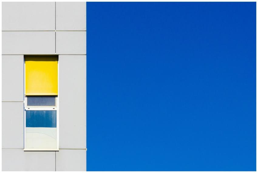 Modern minimalist building facade with vibrant yel