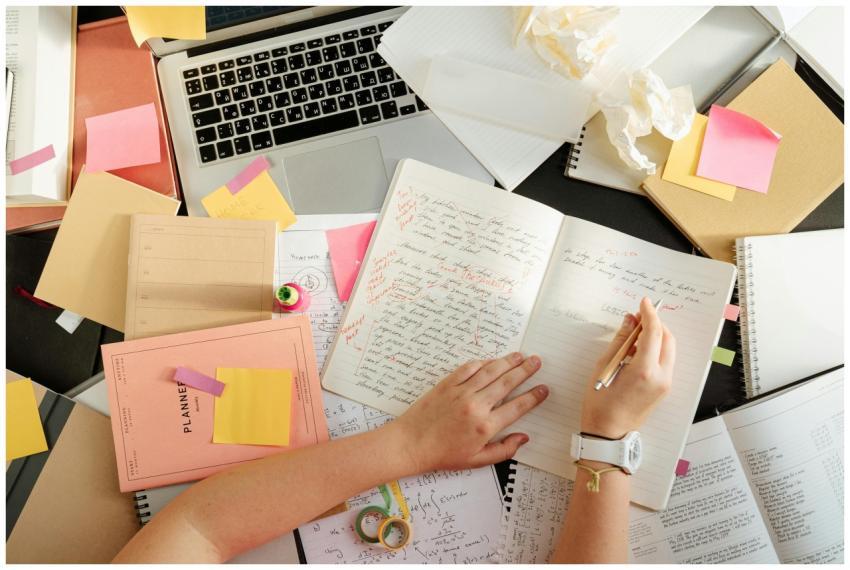 Overhead shot of a person organizing notes and stu